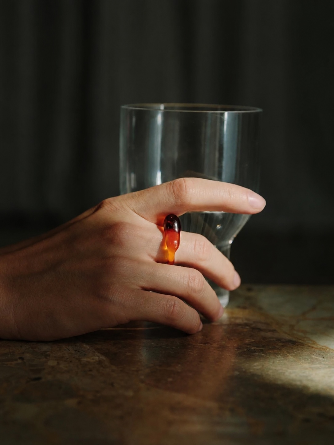 Nathalie Schreckenberg amber ring beside a glass