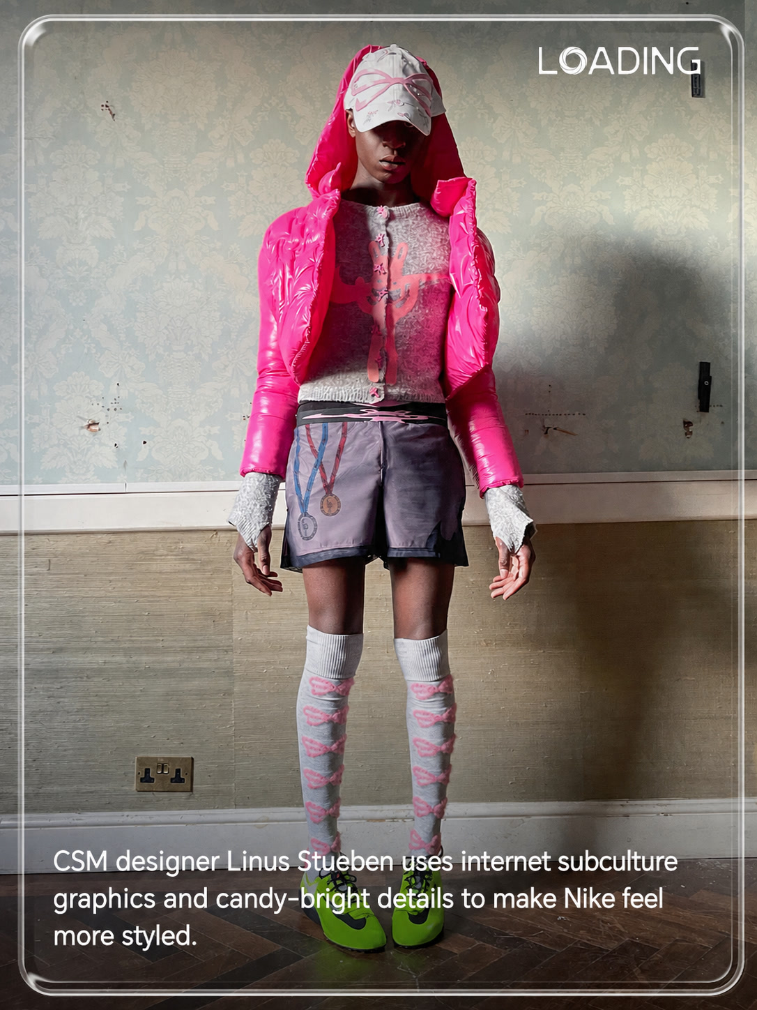 Linus Stueben styled Nike outfit with pink puffer, graphic cap and green sneakers