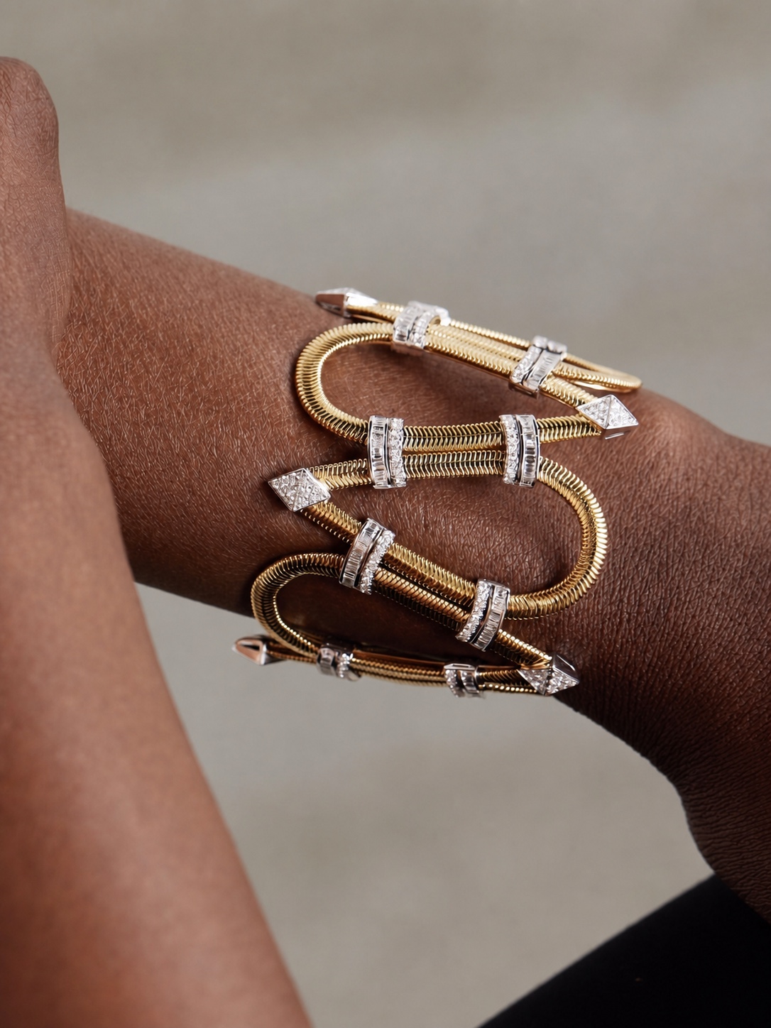Gold and silver Nikos Koulis bracelet with snake-like links