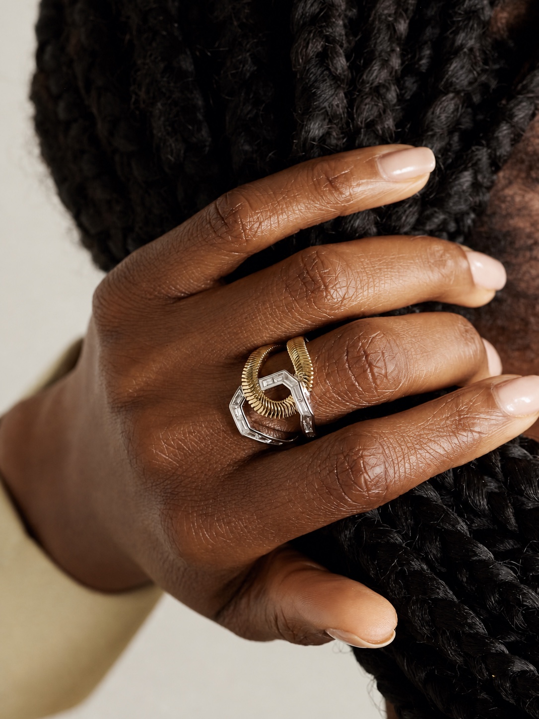 Geometric gold and silver Nikos Koulis ring on a hand