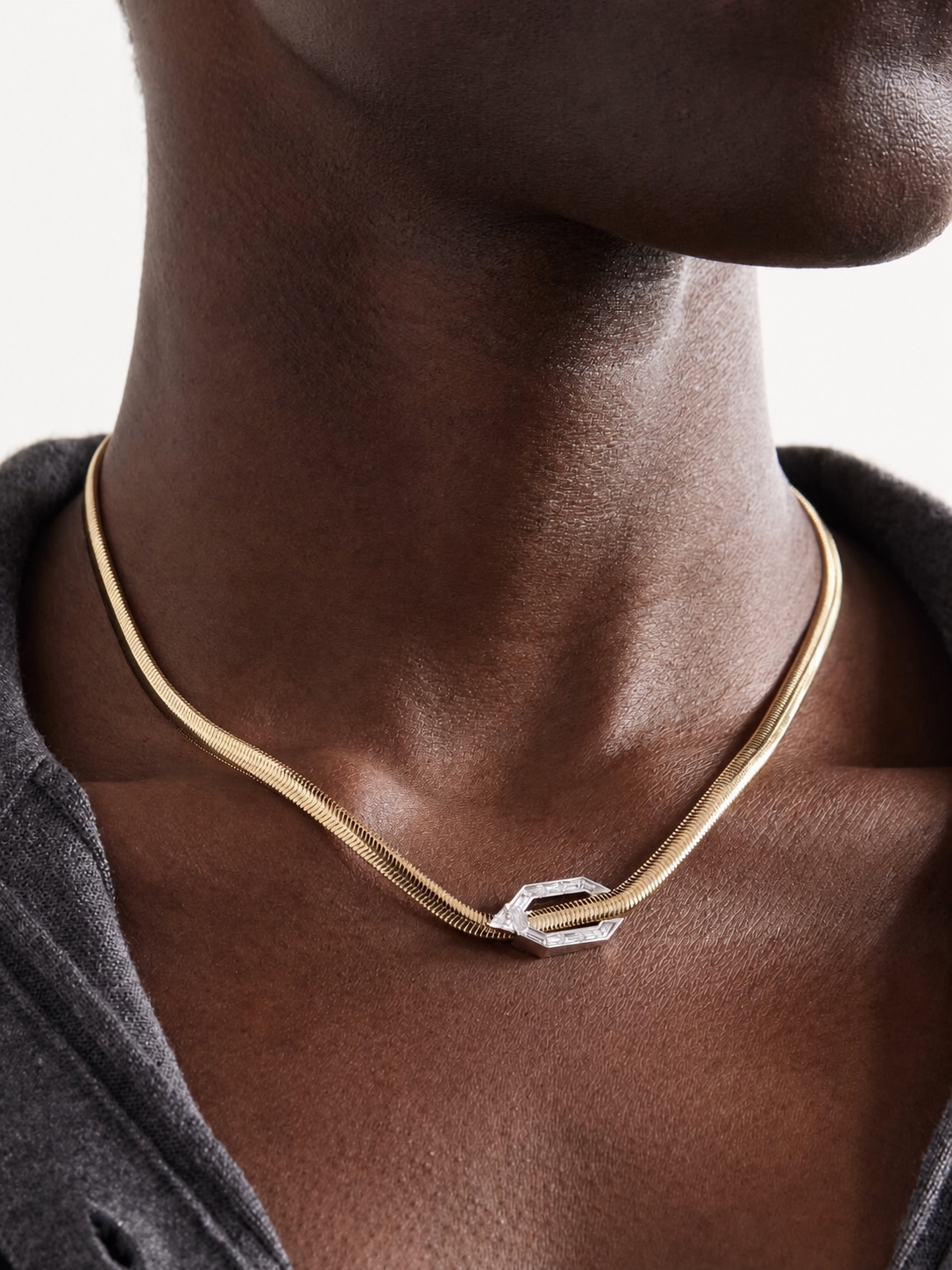 Gold Nikos Koulis necklace with a geometric clasp