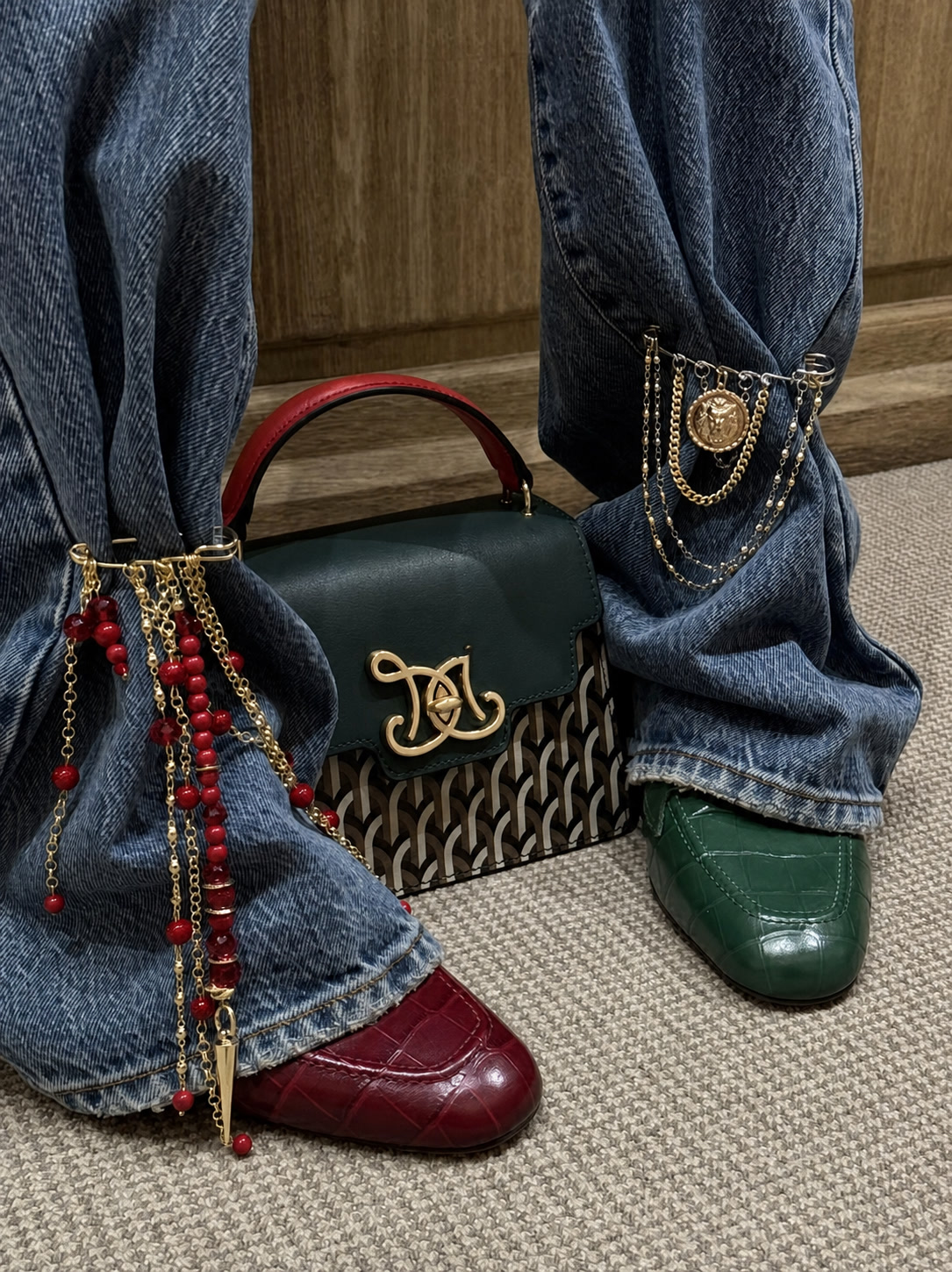 Red beads and gold trouser chains styled with denim, a structured bag and mismatched colored shoes