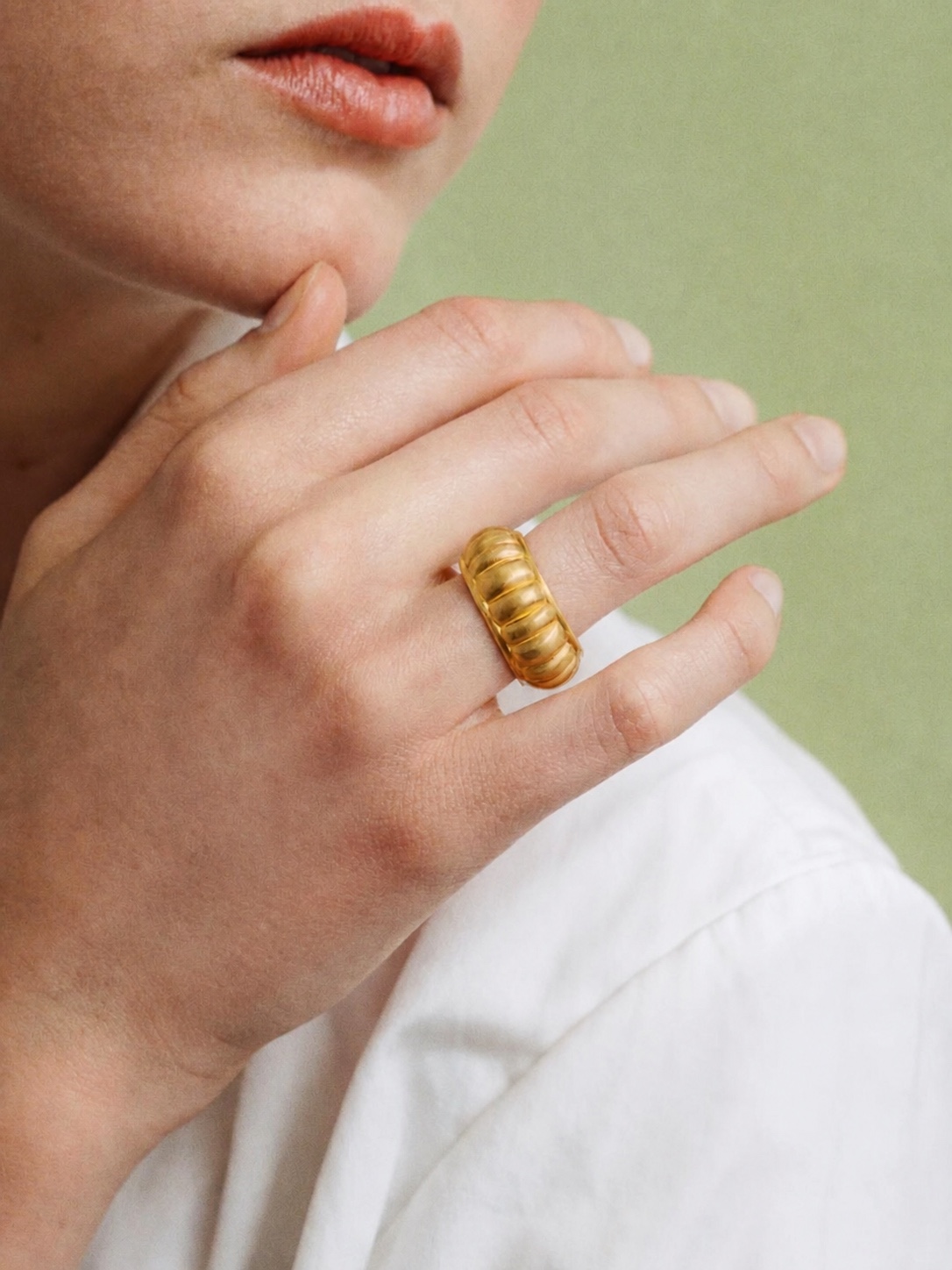 Gold PROUNIS ring worn on a hand