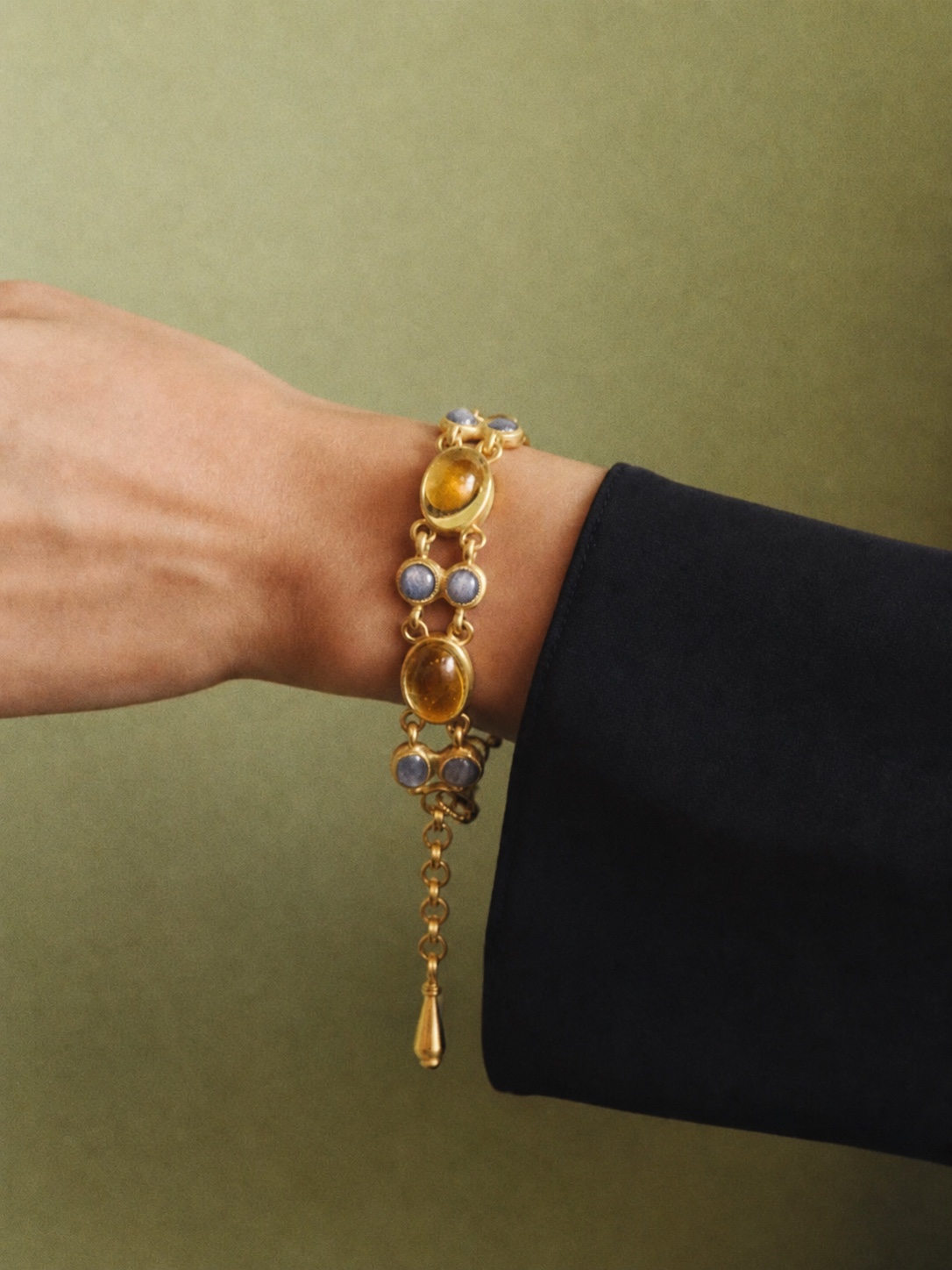 Gold PROUNIS hoop earring on an ear