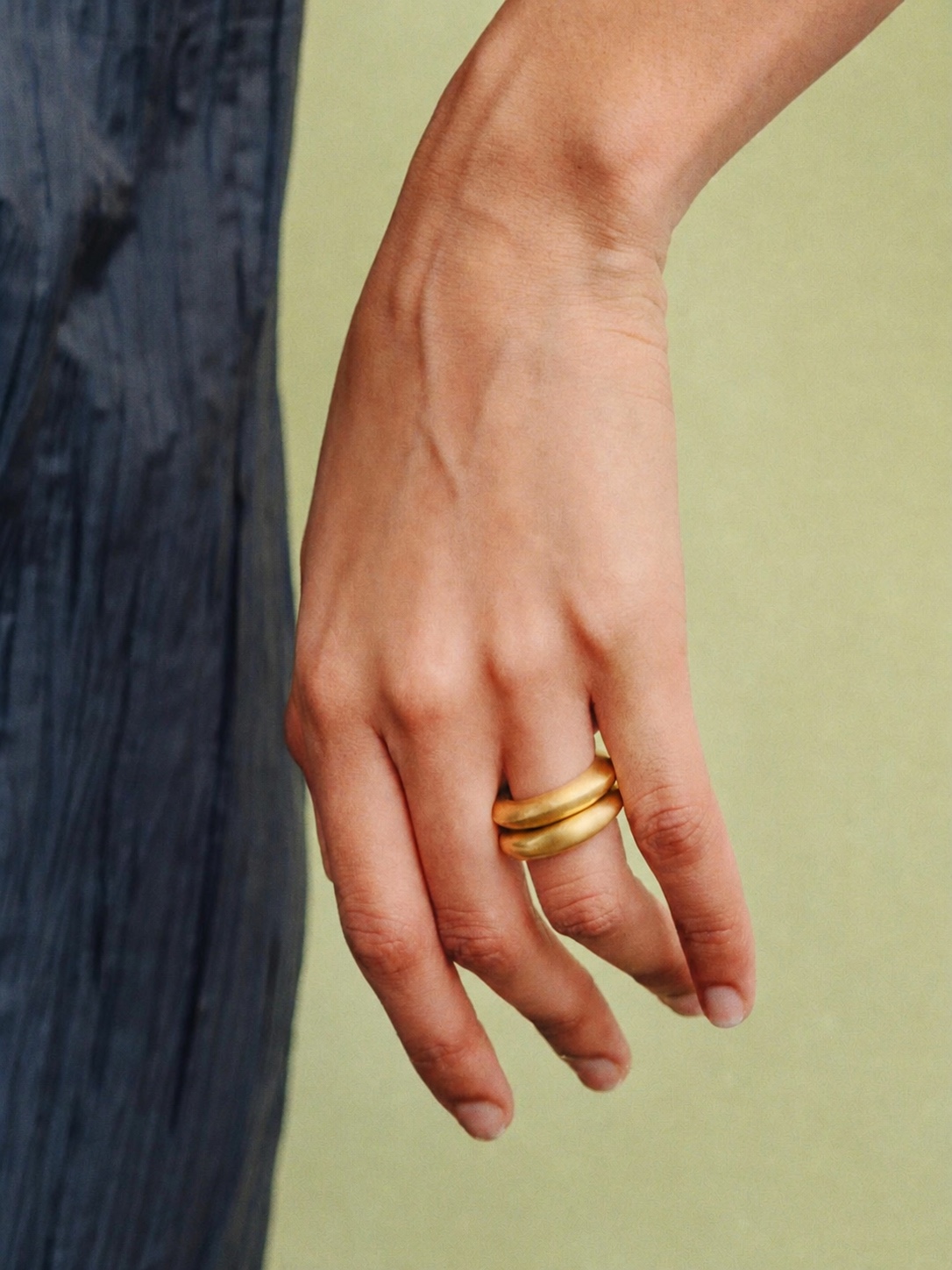 Gold PROUNIS earrings styled on a model