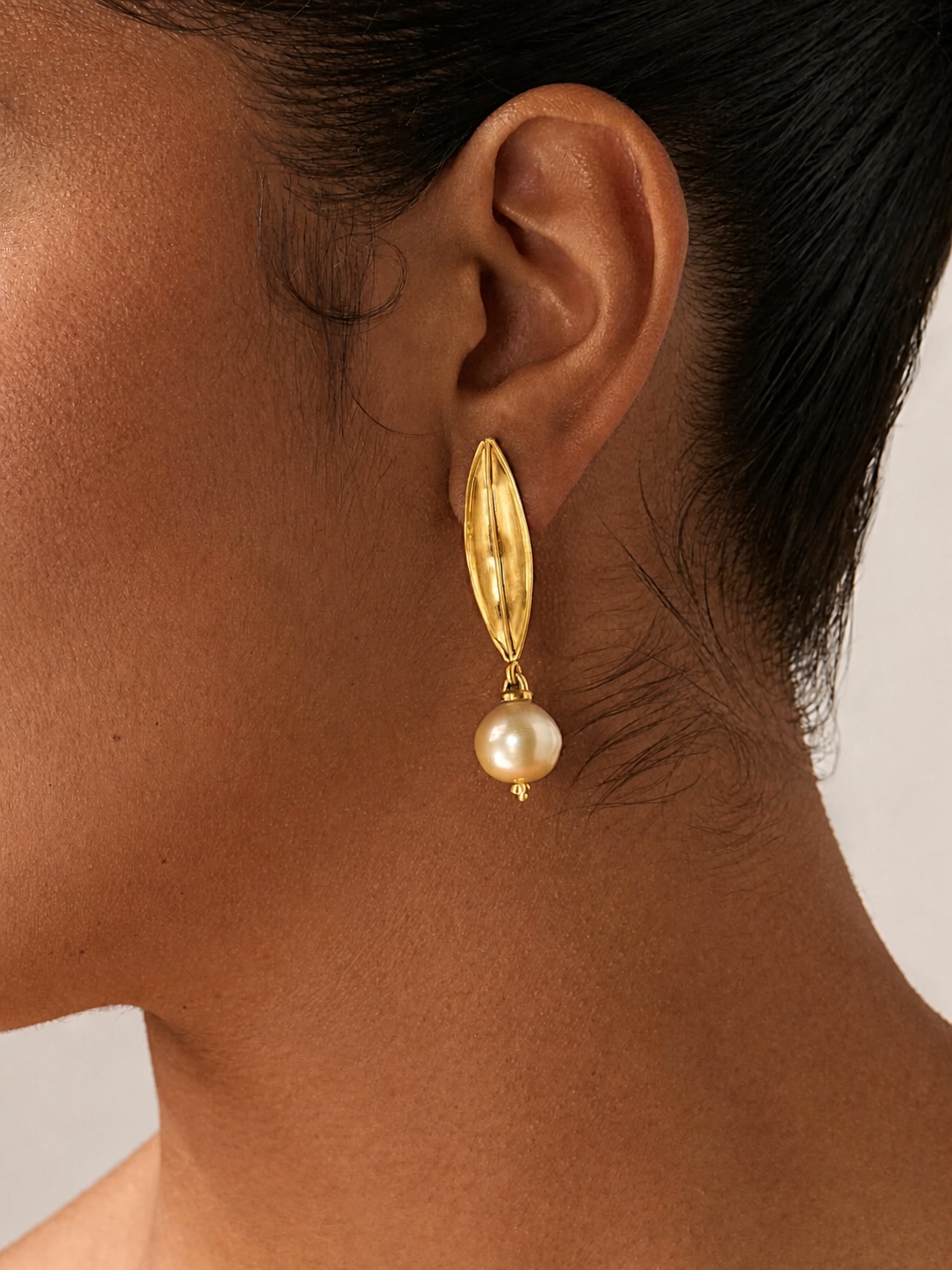Gold PROUNIS pendant against skin