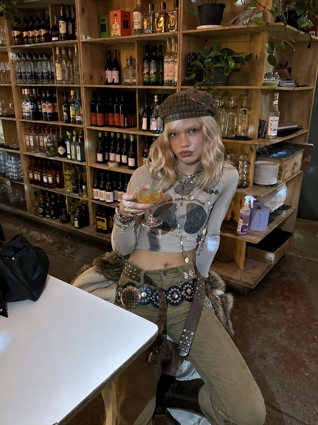 Punk-inspired outfit with wide trousers, belt hardware and a cropped tee