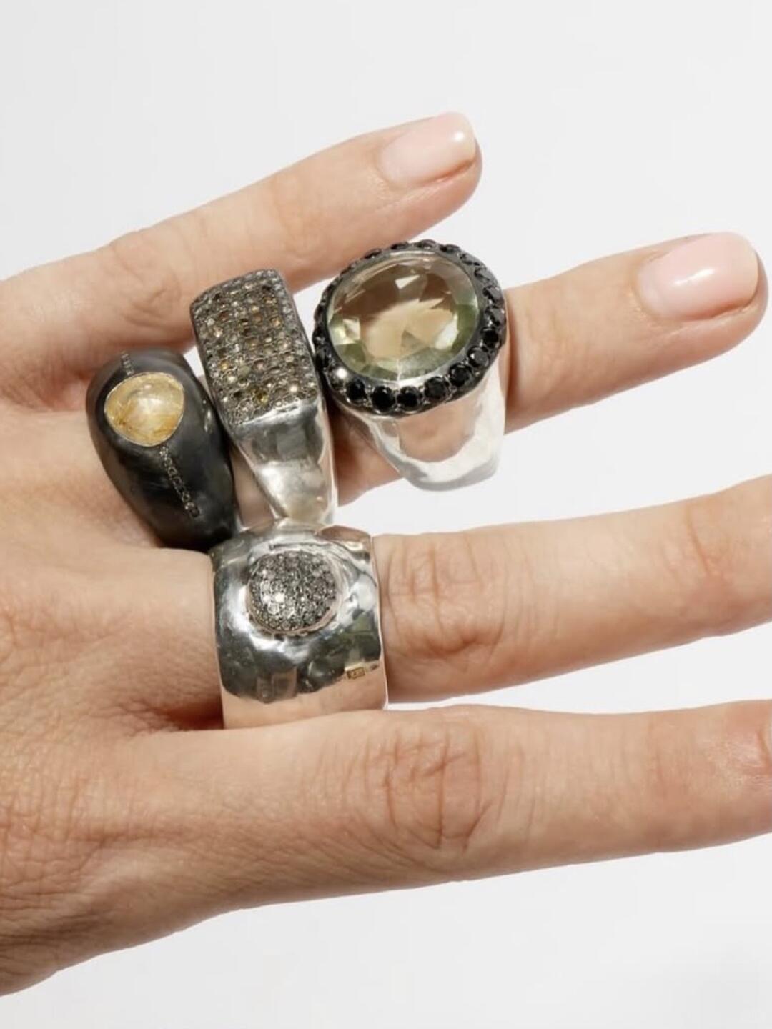 Rosa Maria stacked rings worn against white fabric