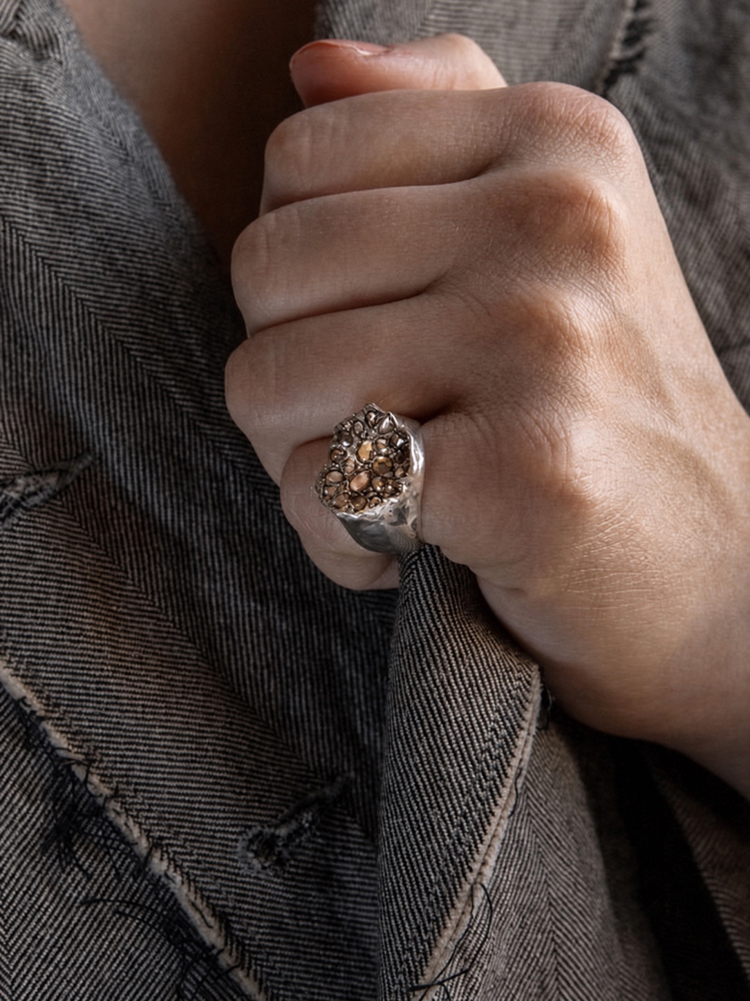 Rosa Maria ring worn over dark fabric