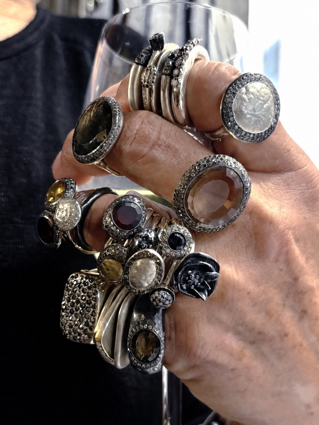 A dense Rosa Maria ring stack covering the hand