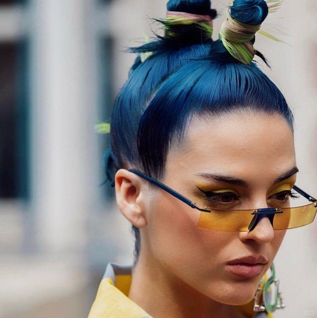Maximalist jewelry styling with strong visual hierarchy