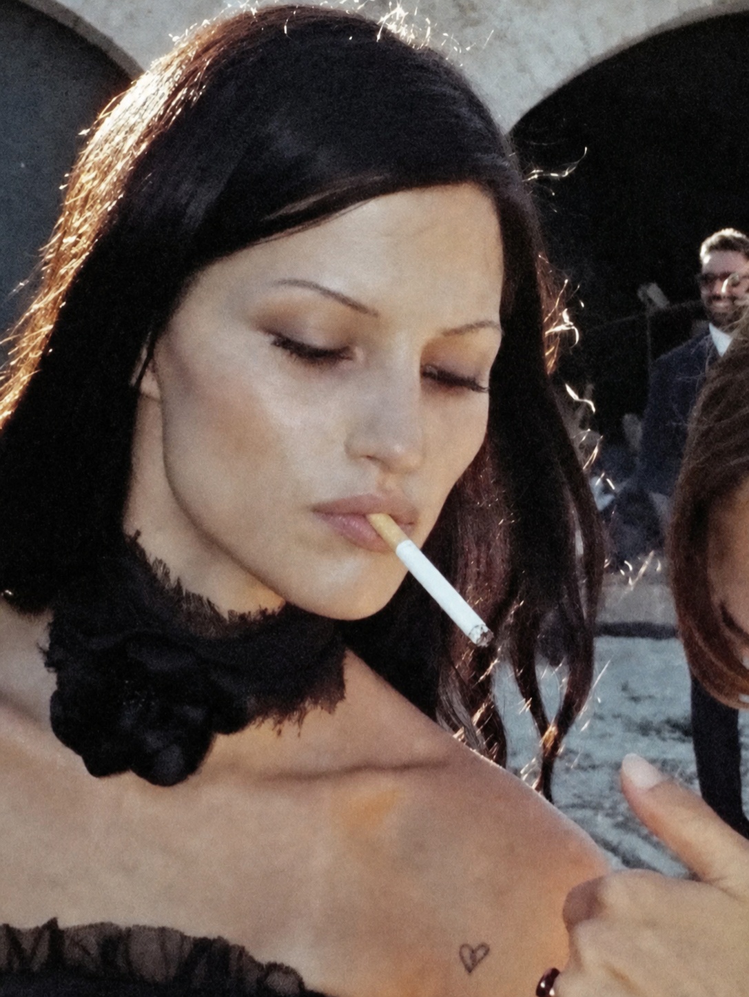 Dark feminine makeup and styling reference with cigarette, black lace and distant gaze