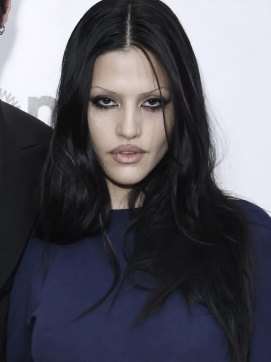 Succubus chic beauty close-up with pale skin, sharp eyes and dark fashion styling