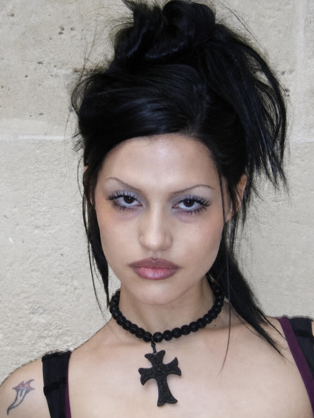 Dark feminine aesthetic outfit with long black hair, pale makeup and gothic necklace detail