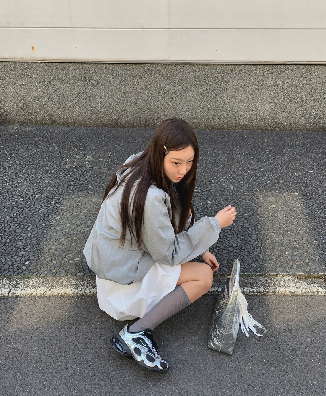 Grey shorts and a relaxed white top styled as a soft summer casual outfit
