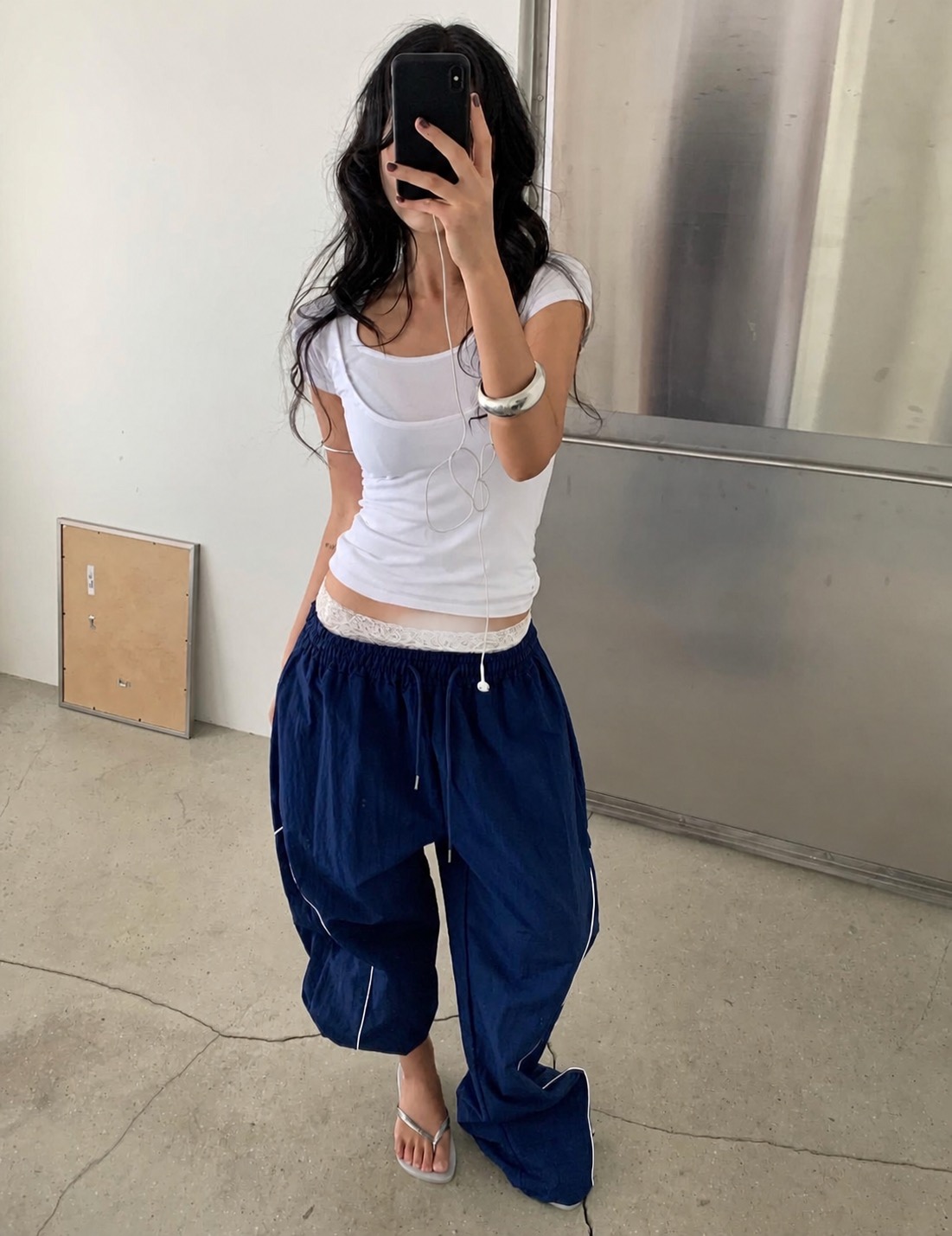 A grey and white casual outfit with soft layers and easy summer proportions