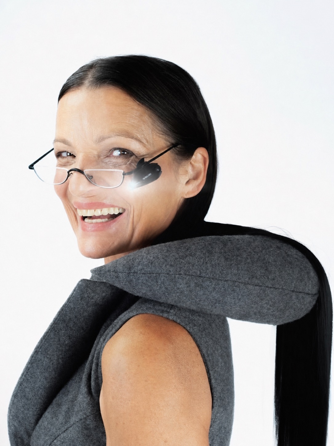 A portrait with a soft grey wearable object wrapping around the shoulders and face.