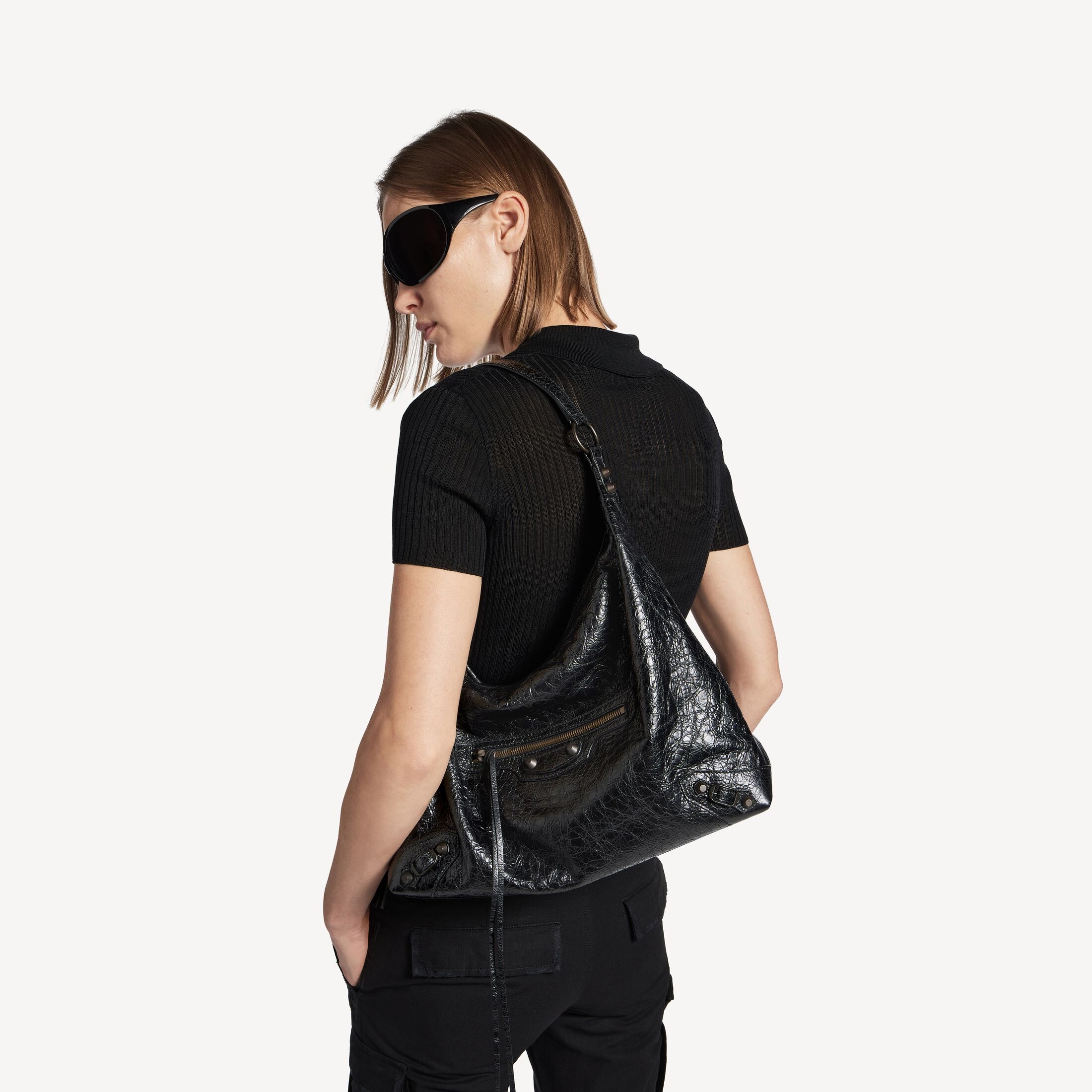 A black Balenciaga Le City Hobo worn close to the body