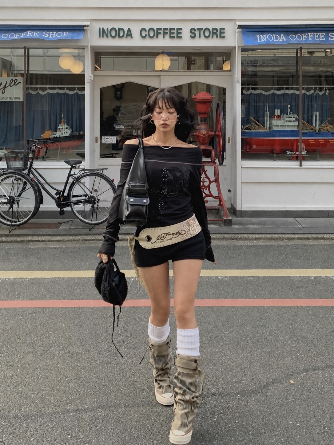 Cool-girl Y2K outfit with leather jacket, boots and relaxed proportions