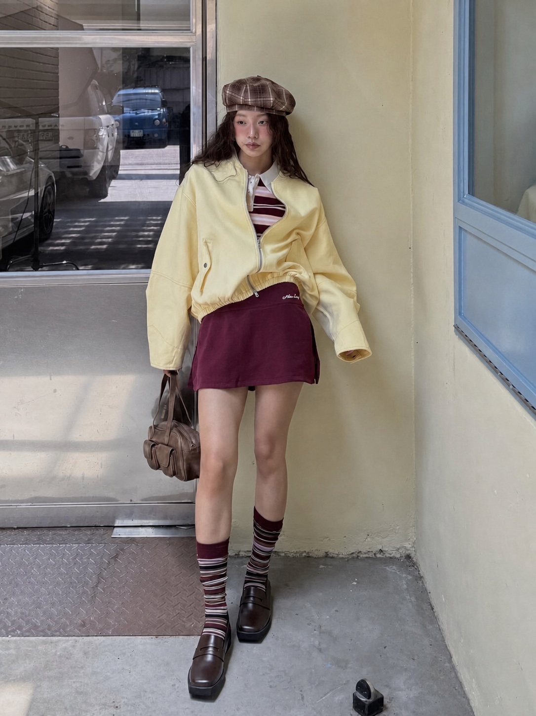 Y2K outfit with playful bag charm, boots and mixed casual layers