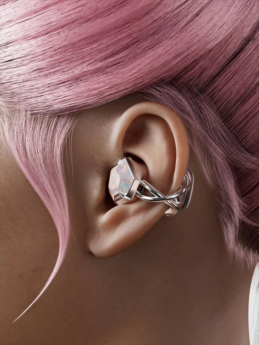 Close-up of an opal Electronic Gems earphone worn against pink hair